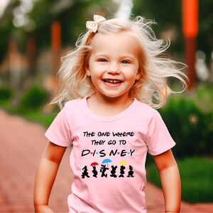May include: A pink t-shirt with the text "The one where they go to DISNEY" with hearts and cartoon characters holding umbrellas.