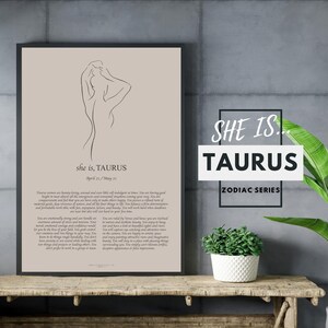 May include: A beige printable poster with a line drawing of a woman. The poster has the text "she is, TAURUS April 20 - May 20" and a description of Taurus personality traits. The poster is framed and hanging on a gray wall.