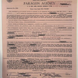 May include: A vintage contract from Paragon Agency, dated March 1975, for a concert engagement. The document includes details about the band Grinderswitch, the venue, and payment terms. The contract is signed by representatives and features the American Federation of Musicians logo.