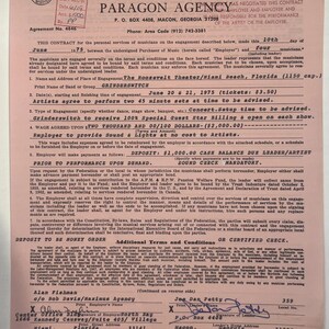 May include: A vintage contract from June 1975 between Paragon Agency and Grinderswitch for a performance at the Roosevelt Theater in Miami, Florida. The document is on aged paper with black ink and includes signatures and details of the engagement.