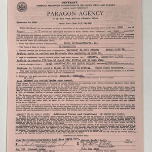 May include: A vintage contract from Paragon Agency, dated August 22, 1975, for a concert featuring Grinderswitch at Ewing Coliseum in Monroe, Louisiana. The document includes details about wages and performance times.