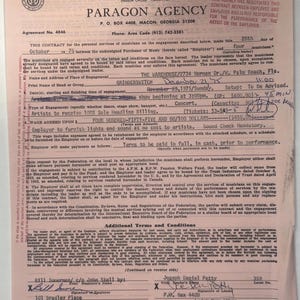 May include: A vintage contract from Paragon Agency, dated December 21, 1975, for a concert engagement. The document includes details about the band, Grinderswitch, and the venue, The Warehouse in Florida. The contract is on pink paper.