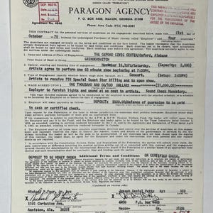 May include: A vintage contract from 1975, issued by Paragon Agency, for a Grinderswitch concert at the Oxford Civic Center in Alabama. The document includes details about the musicians, wages, and performance schedule.