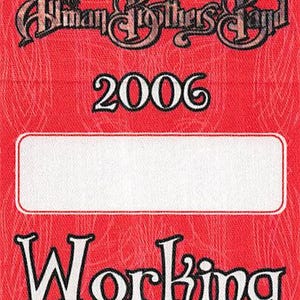 May include: Red rectangular badge with the text "Allman Brothers Band" in a stylized font at the top. The year "2006" is below, and the word "WORKING" is at the bottom. A white rectangular space is in the middle.