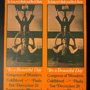 Peut inclure: Affiche de concert vintage orange et marron, annonçant "The Law & Order Circus" et présentant le groupe "Its a Beautiful Day". L'affiche a un design rétro avec des figures et du texte stylisés.