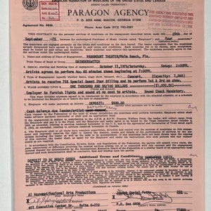 May include: A pink contract form for a musical performance agreement. The contract is dated September 29, 1975, and is for the band Grindswitch. The contract is for a concert at the Paramount Theater in Palm Beach, Florida. The contract states that the band will be paid $1,000.00 for the performance.