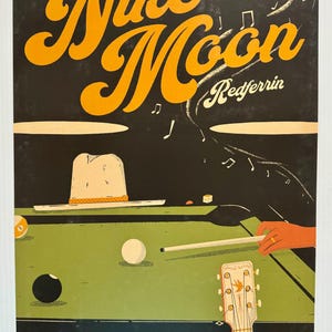 May include: A concert poster for Niko Moon, a musician, performing at The Fillmore in San Francisco. The poster features a pool table with a billiard ball, a cue stick, and a guitar. The text on the poster reads "BILL GRAHAM PRESENTS IN SAN FRANCISCO Niko Moon Redferrin THE FILLMORE 1805 GEARY AT FILLMORE SATURDAY MARCH 23 2024".