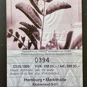 May include: A rectangular concert ticket for an Amorphis performance at the Markthalle in Hamburg on May 23, 1999. The ticket features a botanical illustration, the number 0394, and event details including the time, venue address, and pricing in DM.