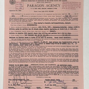 May include: A vintage contract from Paragon Agency, dated July 10, 1975, for a musical performance. The document is pink and features text, including details about the engagement, names, and addresses. The contract is approximately 8.5 x 11 inches.