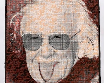May include: A portrait print featuring a stylised image of Stan Lee wearing sunglasses and sticking out his tongue, composed of numerous character names in a grid pattern. The background is dark red with black text, and the bottom reads GENIUS COMES IN MANY CHARACTERS!