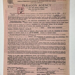 Puede incluir: Un contrato vintage de Paragon Agency, con fecha del 12 de agosto de 1977, para una actuación musical. El documento incluye detalles sobre el lugar, los artistas y las condiciones de pago. El contrato está en papel envejecido con texto y firmas.