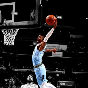 May include: A basketball player in a light blue uniform with white accents, soaring towards the hoop with a basketball. The image is in a basketball arena, with other players in the background. The player is wearing white sneakers with blue accents.