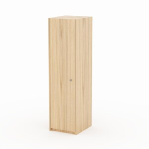 May include: A tall, narrow, rectangular storage cabinet with a light wood grain finish. The unit features a single vertical door with a small, circular silver knob positioned on the right side, showcasing a clean, vertical wood pattern throughout.