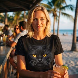 Big Face Black Cat Tshirt Design mockup on black unisex t-shirt flat lay display