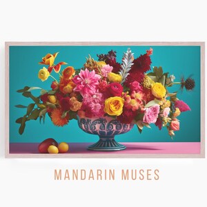 May include: A framed print featuring a vibrant floral arrangement in a decorative blue and white bowl. The flowers are a mix of pink, yellow, orange, and red, set against a teal background and a pink surface. The text "MANDARIN MUSES" is at the bottom.