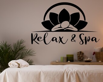 May include: A black and white illustration of a lotus flower with a person lying on top of it. The text "Relax & Spa" is below the illustration.