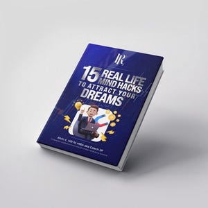 Op de afbeelding: Een hardcover boek met een donkerblauwe kaft met de titel "15 Real Life Mind Hacks to Attract Your Dreams" in witte en zilveren letters. De kaft bevat ook een illustratie van een cartoon zakenman en gouden munten.