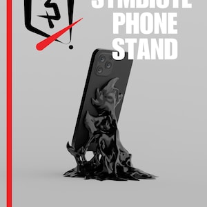 May include: A black smartphone is displayed on a unique phone stand. The stand has a flowing, organic design, and the words "SYMBIOTE PHONE STAND" are printed in white. The phrase "PLASTIC 3D" is printed at the bottom. A red vertical line and a logo are on the left.