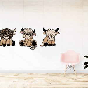 May include: Three cartoon Highland cow illustrations in brown and black with white accents. The cows are sitting and facing forward. The cows are on a white background.
