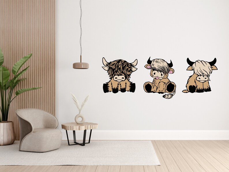 May include: Three cartoon Highland cow illustrations in a row on a white wall. The cows are brown and white with black eyes and noses. They are sitting with their legs tucked under them and their tails curled up.