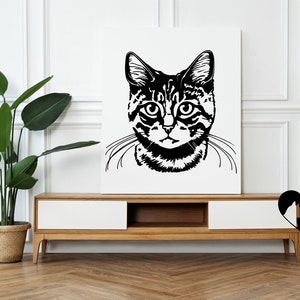 May include: Black and white illustration of a cat's face with a focused expression. The cat has stripes and is looking directly at the viewer. The illustration is on a white background.