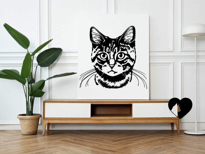 May include: Black and white illustration of a cat's face with a focused expression. The cat has stripes and is looking directly at the viewer. The illustration is on a white background.