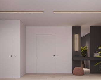 May include: Two long, linear wooden ceiling light fixtures with integrated LED strips installed in a white ceiling. The room features two white doors with black handles, a dark gray wall section with a vertical wall light, a console, and a stool.