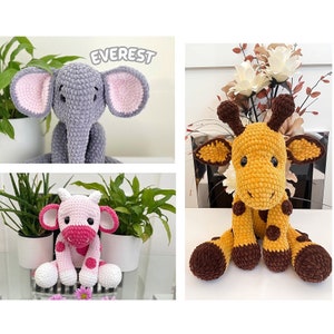 May include: Handmade crochet stuffed animals: a grey elephant with pink ears, a yellow and brown giraffe, and a pink and white cow. The elephant has the name "Everest" above it. These soft toys are suitable for children.