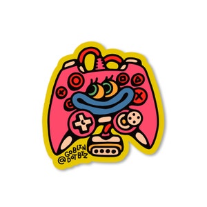 May include: A pink and yellow cartoon illustration of a video game controller with a face and three eyes. The text "GOBLIN DOTBIZ" is at the bottom of the image.