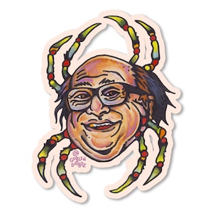 May include: A cartoon illustration of a man's face with glasses, surrounded by a colorful spider with green legs and red and blue beads. The spider's legs are drawn in a stylized way, with the man's face in the center. The artwork is signed "Goblin Doodles" in the lower right corner.