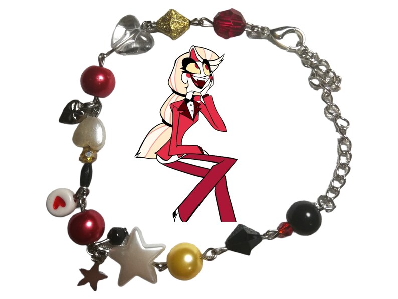 May include: A silver chain bracelet with red, white, black, and gold beads. The bracelet also features charms in the shape of hearts, stars, and a cartoon character.