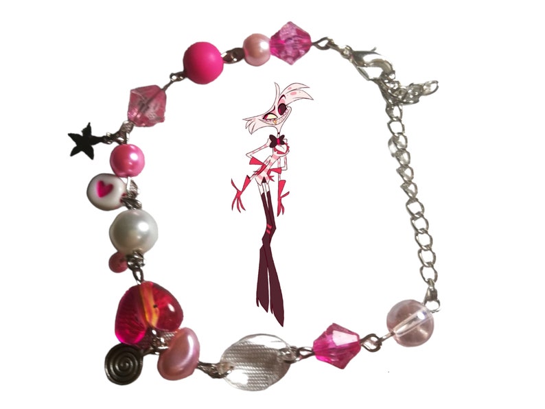 May include: A pink and silver charm bracelet with a variety of beads, including hearts, stars, and pearls. The bracelet also features a clear glass bead and a pink and silver charm with a cartoon character.