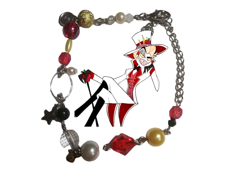 May include: A red, white, and gold charm bracelet with a cartoon character charm. The character is wearing a white suit and a red hat with a crown. The bracelet has a variety of beads, including red, white, gold, and black.
