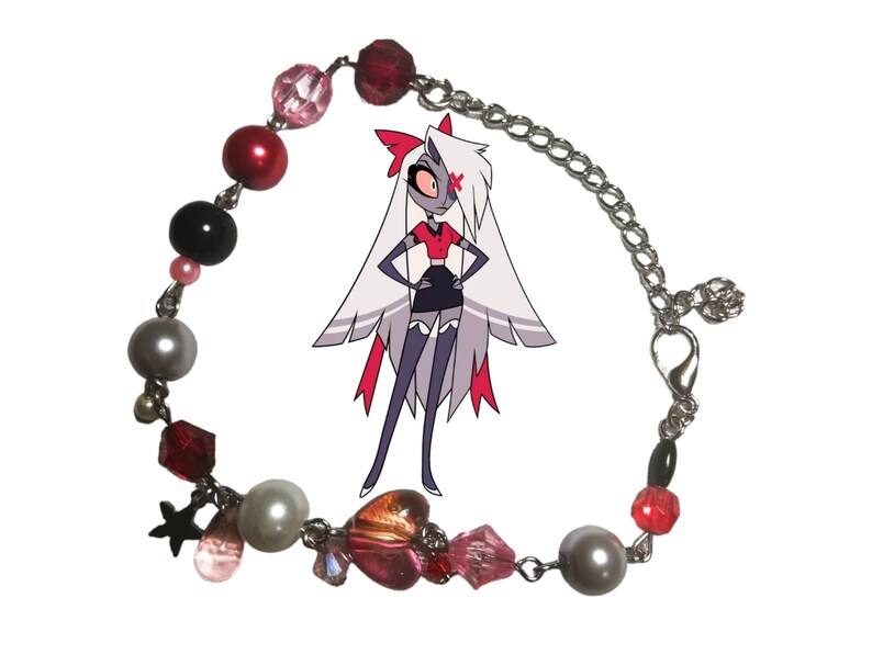 May include: A silver chain bracelet with red, pink, black, and white beads, a star charm, and a heart charm. The bracelet also features a small silver clasp.