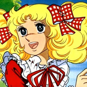 May include: A cartoon illustration of a young girl with blonde curly hair and large blue eyes. She wears a red dress with a white ruffled collar and a red bow. Two red and white checkered bows adorn her hair.