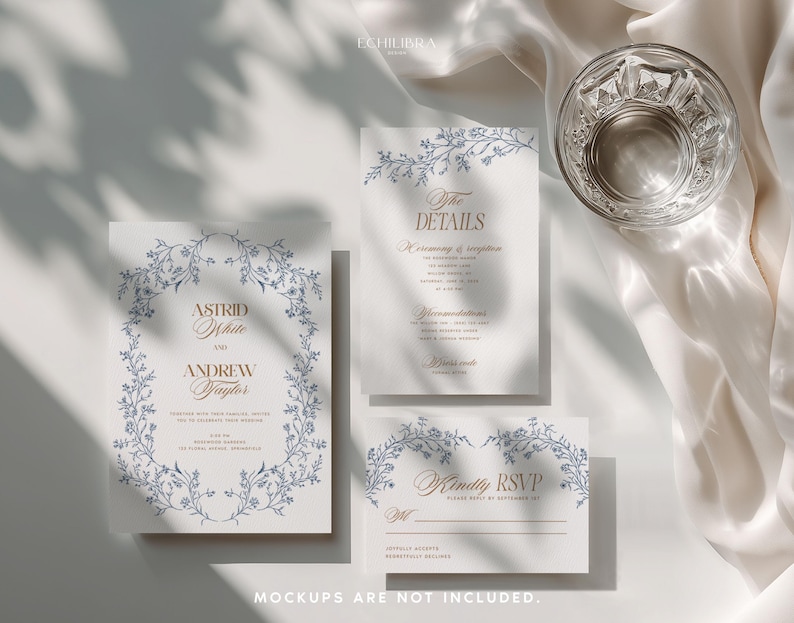 May include: A wedding invitation suite featuring three white rectangular cards with blue floral borders and gold text. The cards include an invitation for Astrid White and Andrew Taylor, a details card, and an RSVP card. A clear glass is visible.
