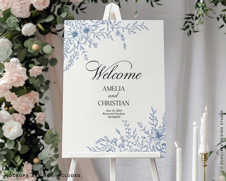May include: A rectangular wedding welcome sign on a white easel featuring blue floral line art in the top left and bottom right corners. The text reads Welcome, AMELIA and CHRISTIAN, June 15, 2024, Rosewood Gardens, Springfield in black font.