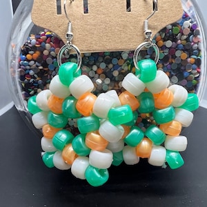 May include: A pair of green, white, and orange beaded earrings with silver hooks.