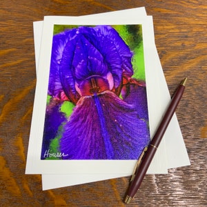 May include: A close-up of a purple iris flower with a green background. The flower is in focus and the background is blurred. The flower has a deep purple color and a white center. The image is signed "Hoarer" in the bottom left corner.