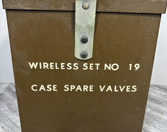 May include: A brown metal box with a metal latch and the text "WIRELESS SET NO 119 CASE SPARE VALVES" printed in white.
