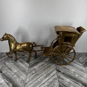 Brass horse drawn carriage statue