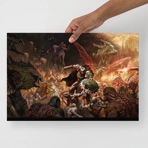 May include: A poster print showing a battle scene with a warrior in green armour fighting against various monstrous creatures. The artwork features a dynamic composition with a fiery, chaotic background and detailed character designs.