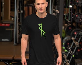 May include: A black short-sleeved t-shirt with a green rune symbol on the front. The person wearing the shirt is standing in a gym.