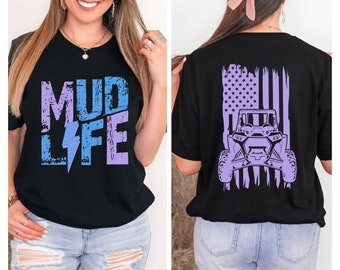 May include: Black t-shirt with a purple and blue "Mud Life" graphic on the front and a purple American flag with a silhouette of an off-road vehicle on the back.