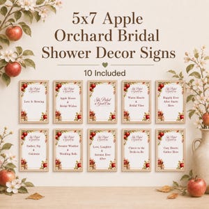 May include: A set of ten 5x7 inch rectangular signs with light wood frames, featuring apple orchard graphics and text including 'She Picked a Good One', 'Love Is Brewing', 'Apple Kisses & Bridal Wishes', 'Warm Hearts & Bridal Vibes', and more.