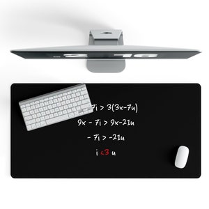 May include: Black desk mat with white handwritten math equations and the phrase "i <3 u" in red. A white keyboard and a white mouse are on the mat.