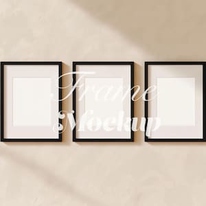 May include: Three black framed art mockups with white matting are displayed on a beige textured wall. The frames are rectangular and arranged horizontally. The text "Frame Mockup" is overlaid on the frames.