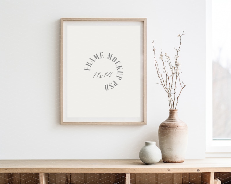 May include: A light wood frame mockup with a white background and the text "FRAME MOCKUP 11x14 PSD" inside the frame. A vase with dried branches and white flowers sits on a light wood shelf with a light wood background.