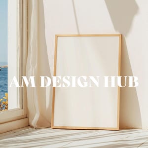 May include: A light wood frame with a white background. The frame is sitting on a white surface with a light wood floor. The text "AM DESIGN HUB" is visible in the image.