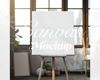 May include: A white canvas on an easel in a studio setting. The canvas is blank and ready for painting. The word "Canvas Mockup" is written in white text on the canvas.